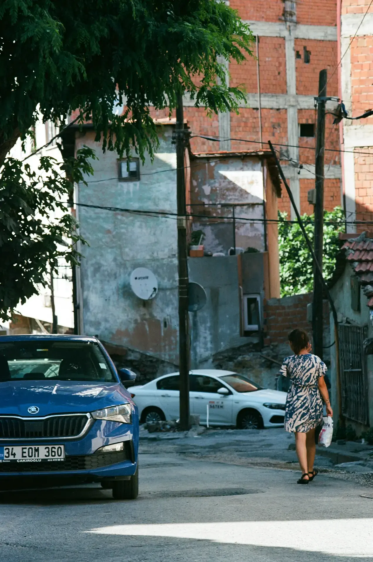 A woman presumbly walking home with a grocery bag